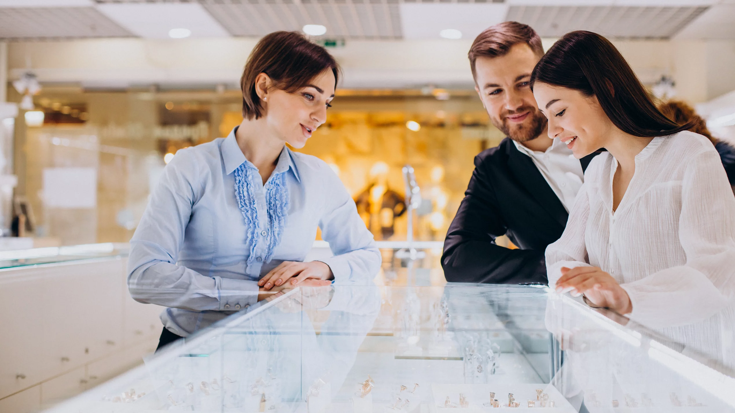 Couple at jewelry shop choosing a necklace together